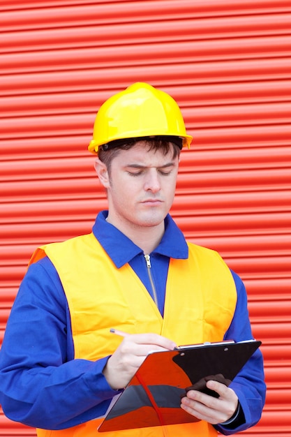 Handsome male engineer writing his report 