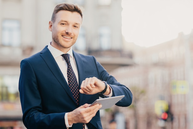 Handsome male entrepreneur comes on meeting with business people