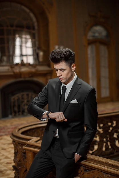 Handsome male model in a new suit in a beautiful room