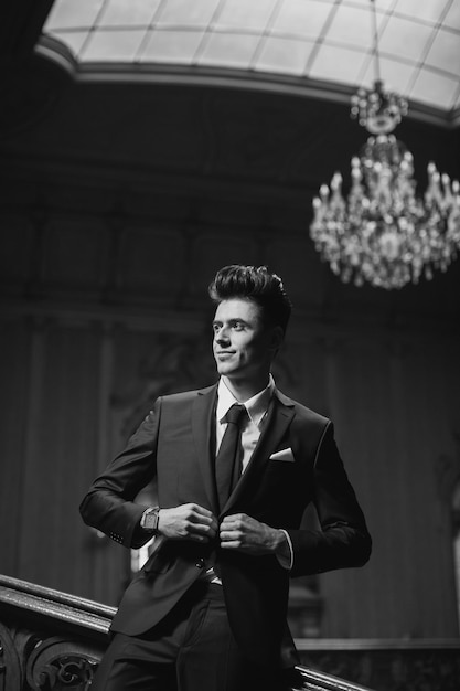 Handsome male model in a new suit in a beautiful room