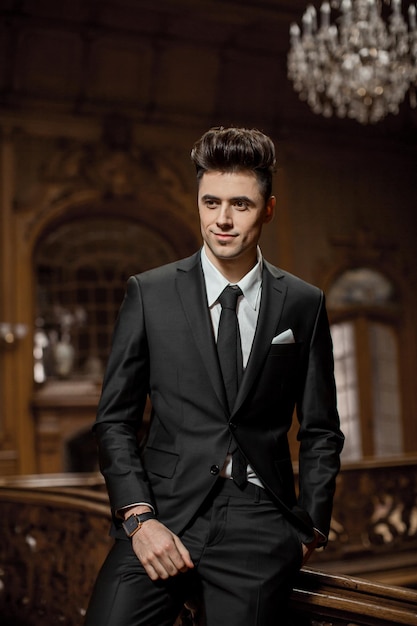 Handsome male model in a new suit in a beautiful room