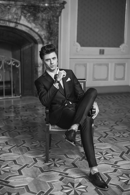 Handsome male model in a new suit in a beautiful room