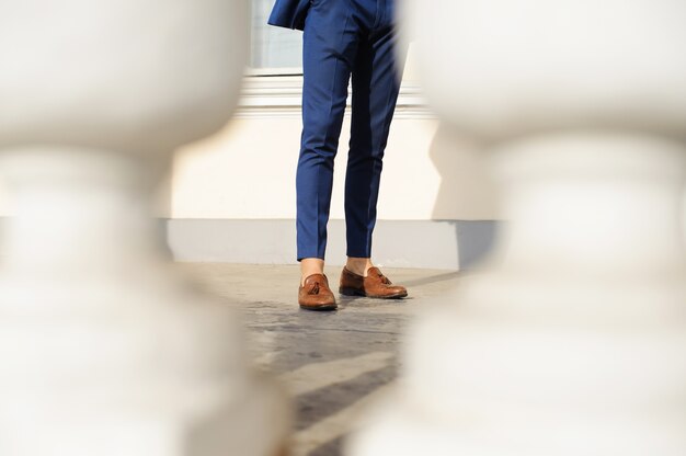 Handsome male model posing wearing a blue suit.