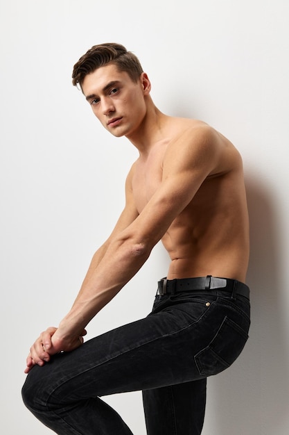 Handsome male nude torso black pants portrait studio isolated background