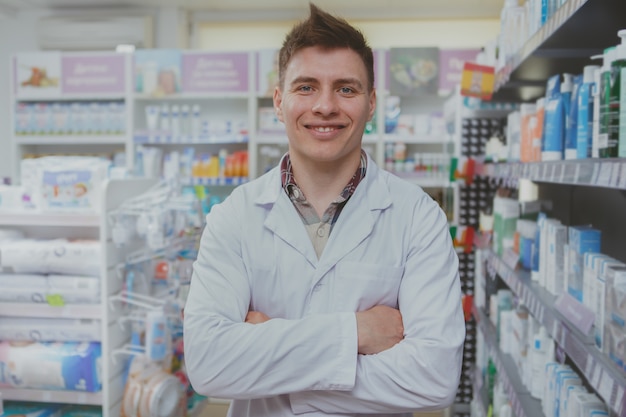 Handsome male pharmacist working at his drugstore