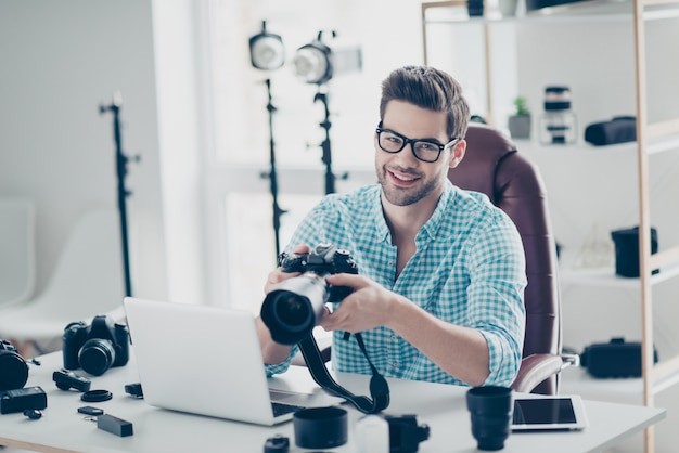 Handsome male photographer working at desk