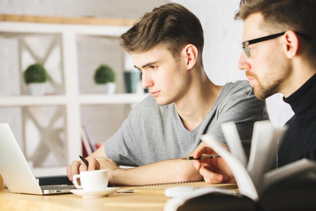 Handsome males discussing project