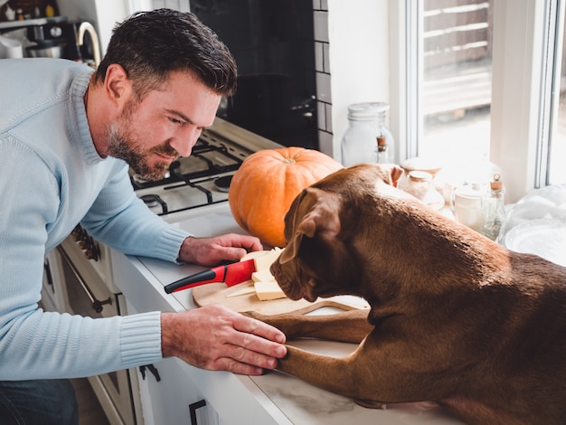 Handsome man and an adorable, pretty puppy