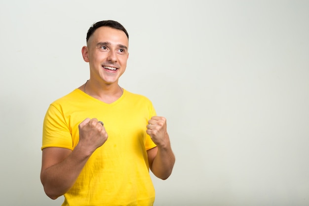 handsome man against white wall