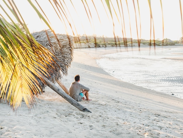 Handsome man on the beach looking into the distance