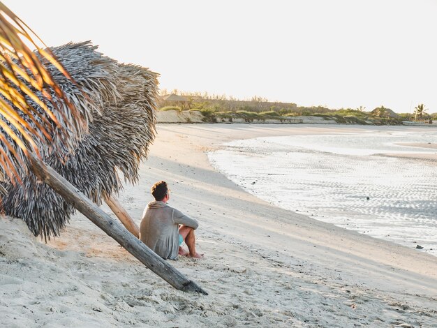 Handsome man on the beach looking into the distance