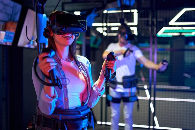 Handsome man and beautiful young woman with glasses of virtual
reality. vr, games, entertainment, future technology concept.
couple with virtual reality headset having fun together.