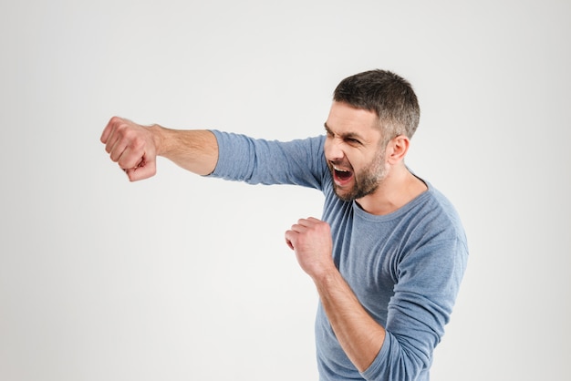 Handsome man boxing isolated