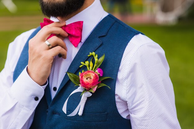 Handsome man, bridegroom close up with pink bow