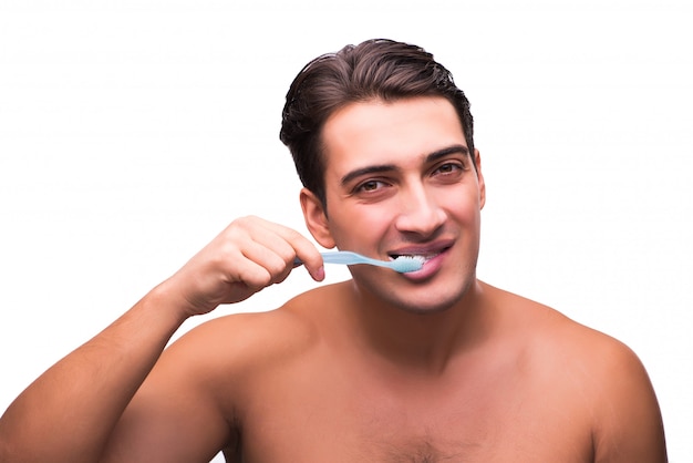 Handsome man brushing his teeth isolated on white