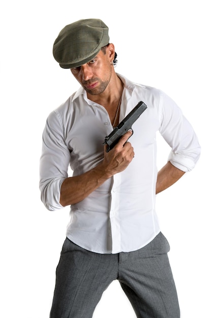 Handsome man in cap with a gun