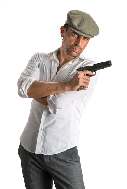 Handsome man in cap with a gun