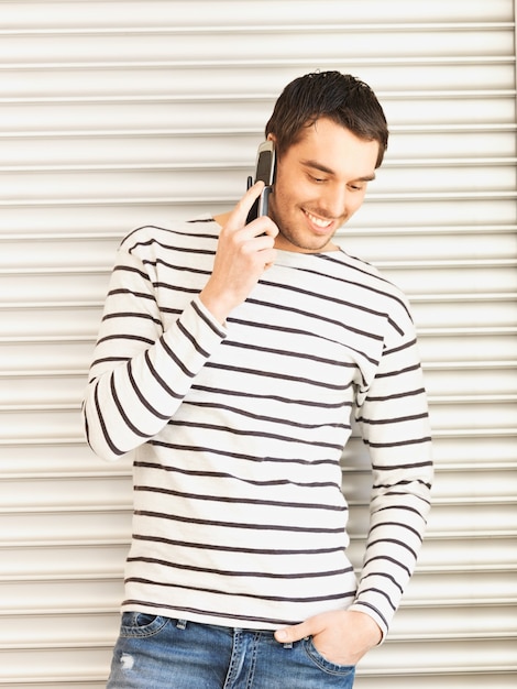 handsome man in casual clothes talking on the phone