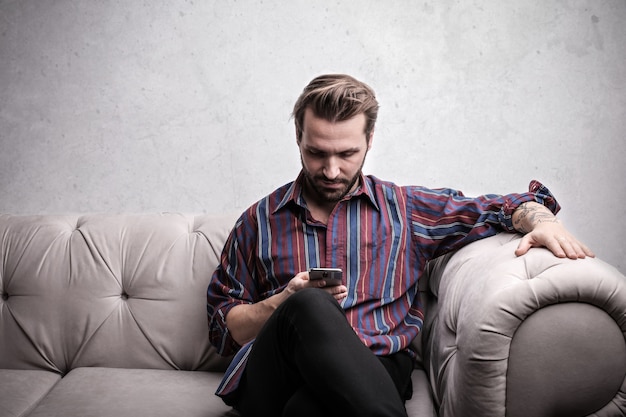 Handsome man checking his smartphone