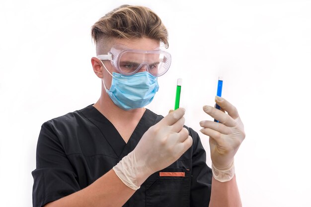 Handsome man chemist with flask making experiment in laboratory