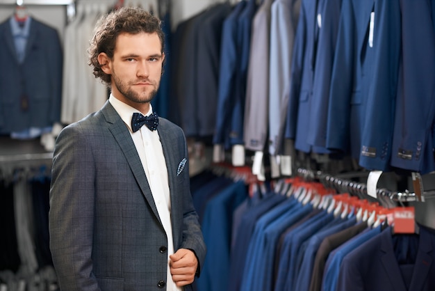 Handsome man demonstrating his choice in shop.