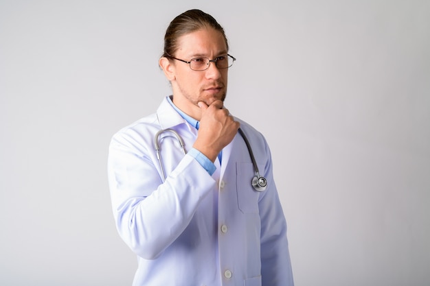  handsome man doctor wearing eyeglasses against white wall