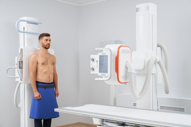 Handsome man doing ultrasound diagnostic after virus