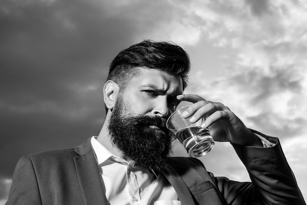 Handsome man drinking cognac or whiskey scotch and cognac