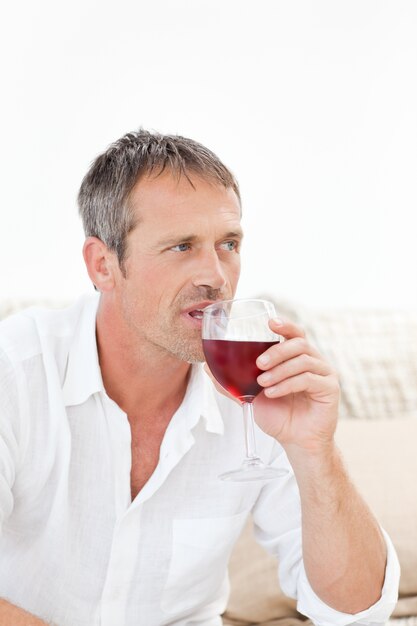 Handsome man drinking some red wine