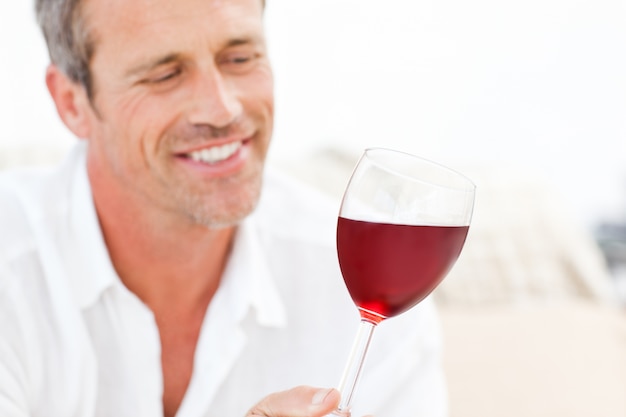 Handsome man drinking some red wine 