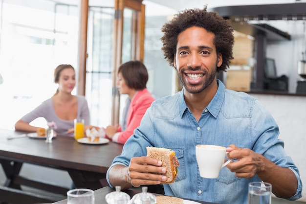 Handsome man eating a sandwich