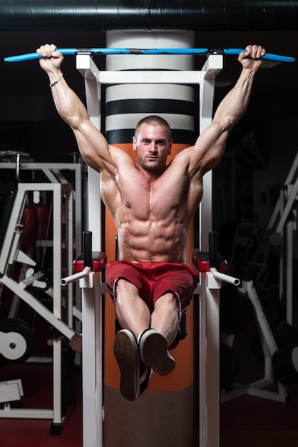 Handsome Man Exercising His Abs At The Gym