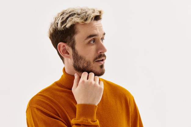 Handsome man fashion hairstyle hand near face cropped view light background