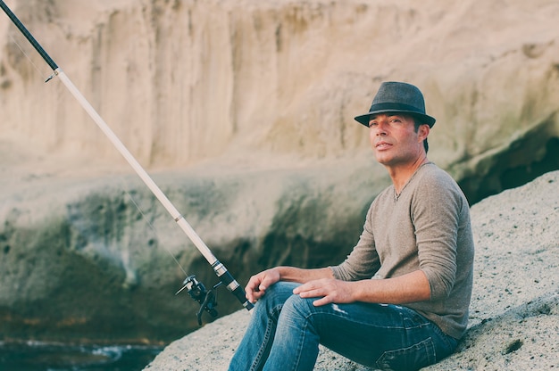 Handsome man fishing during his day off