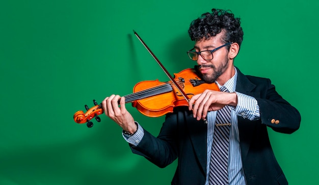Handsome man in formal suit playing violin isolated close up of\
a music teacher playing his violin isolated person in suit playing\
violin on isolated background