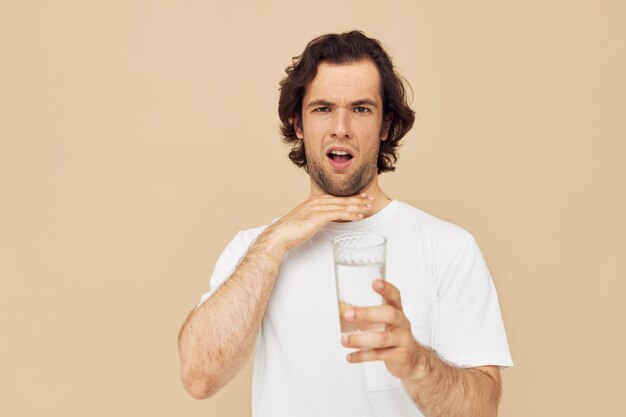 Handsome man glass of water in his hands emotions posing isolated background