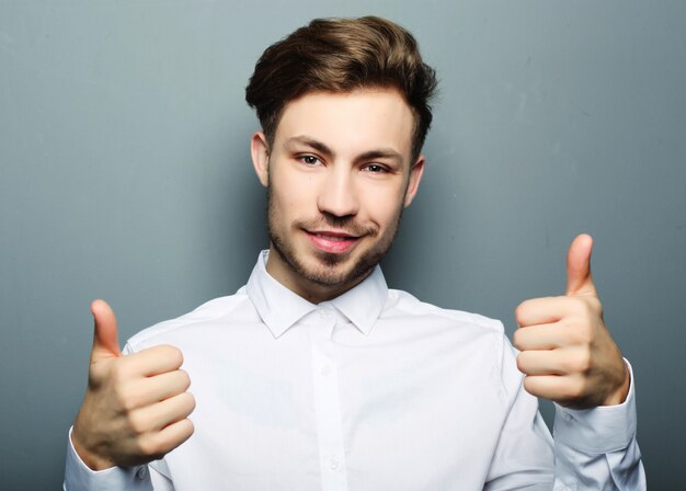 Handsome man happy smile, hold hand with ok gesture sign