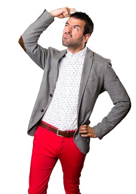 Handsome man having doubts on isolated background