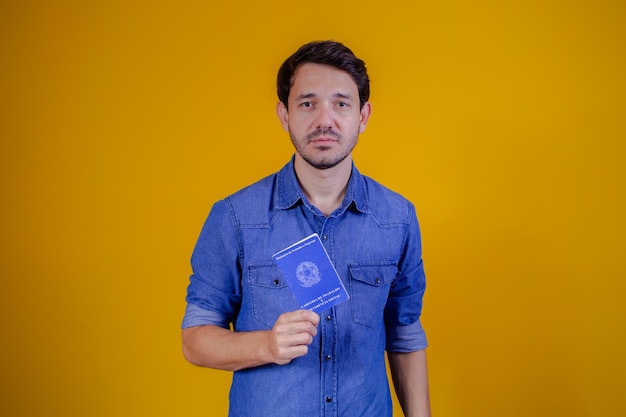 Handsome man holding a brazilian passport