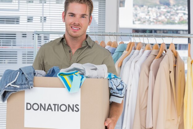 Handsome man holding donation box