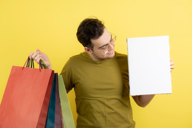  handsome man holding empty canvas and shopping bags. 