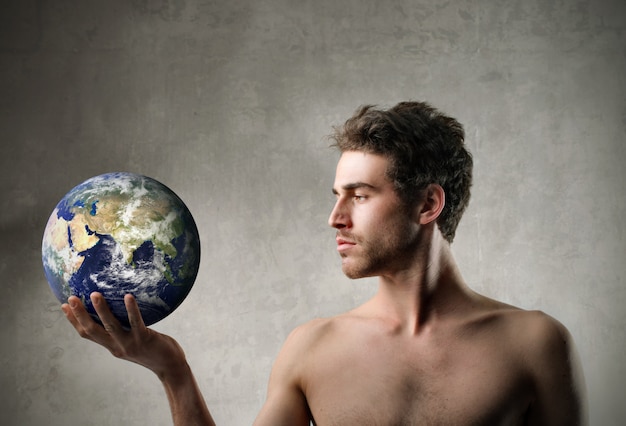 Handsome man holding the globe