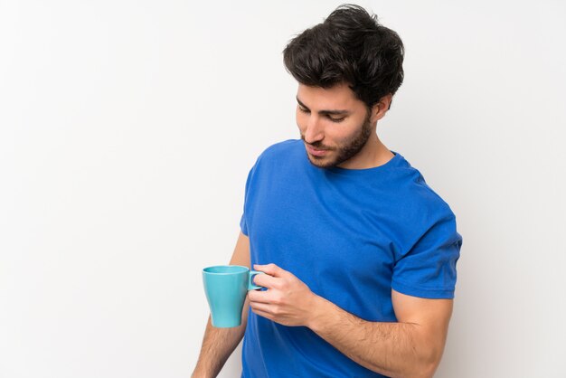 Handsome man holding hot cup of coffee