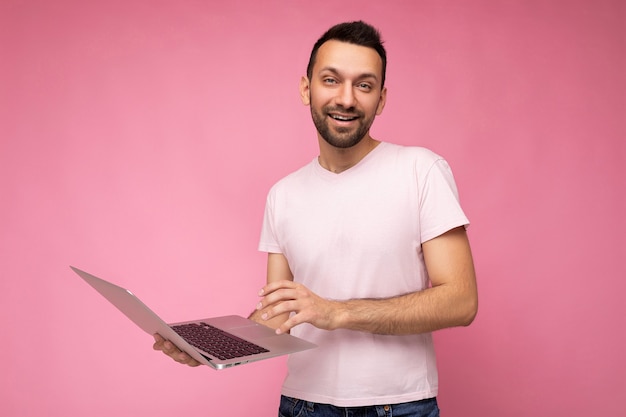 Handsome man holding laptop computer