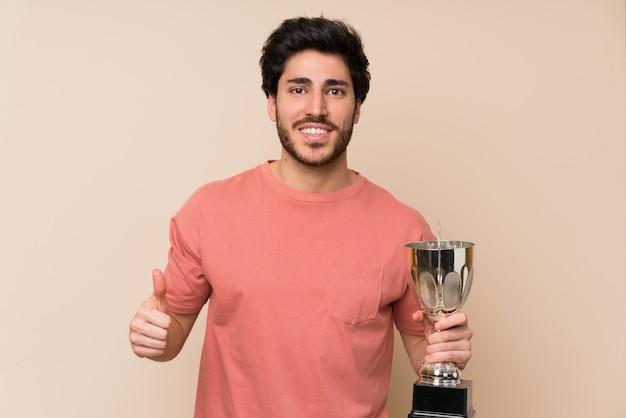 Handsome man holding a trophy