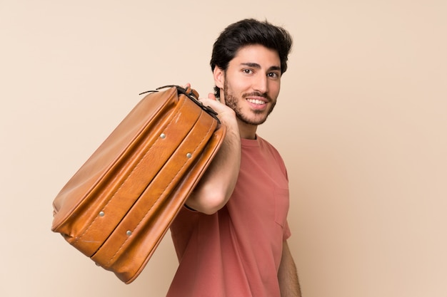 Handsome man holding a vintage briefcase