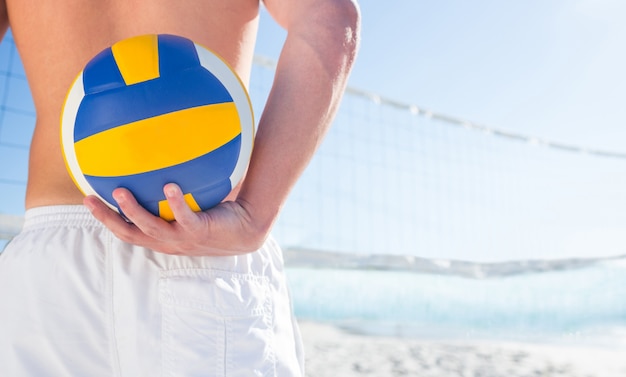 Handsome man holding volleyball