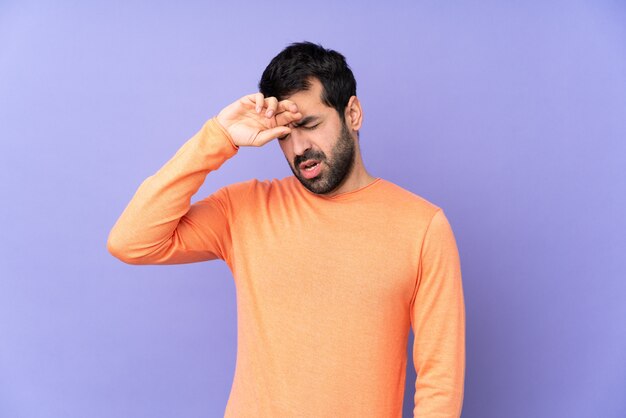 Handsome man over isolated purple