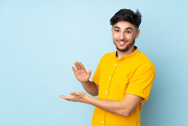 Handsome man over isolated wall applauding