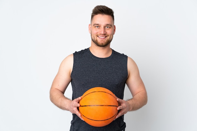 Handsome man isolated on white wall playing basketball